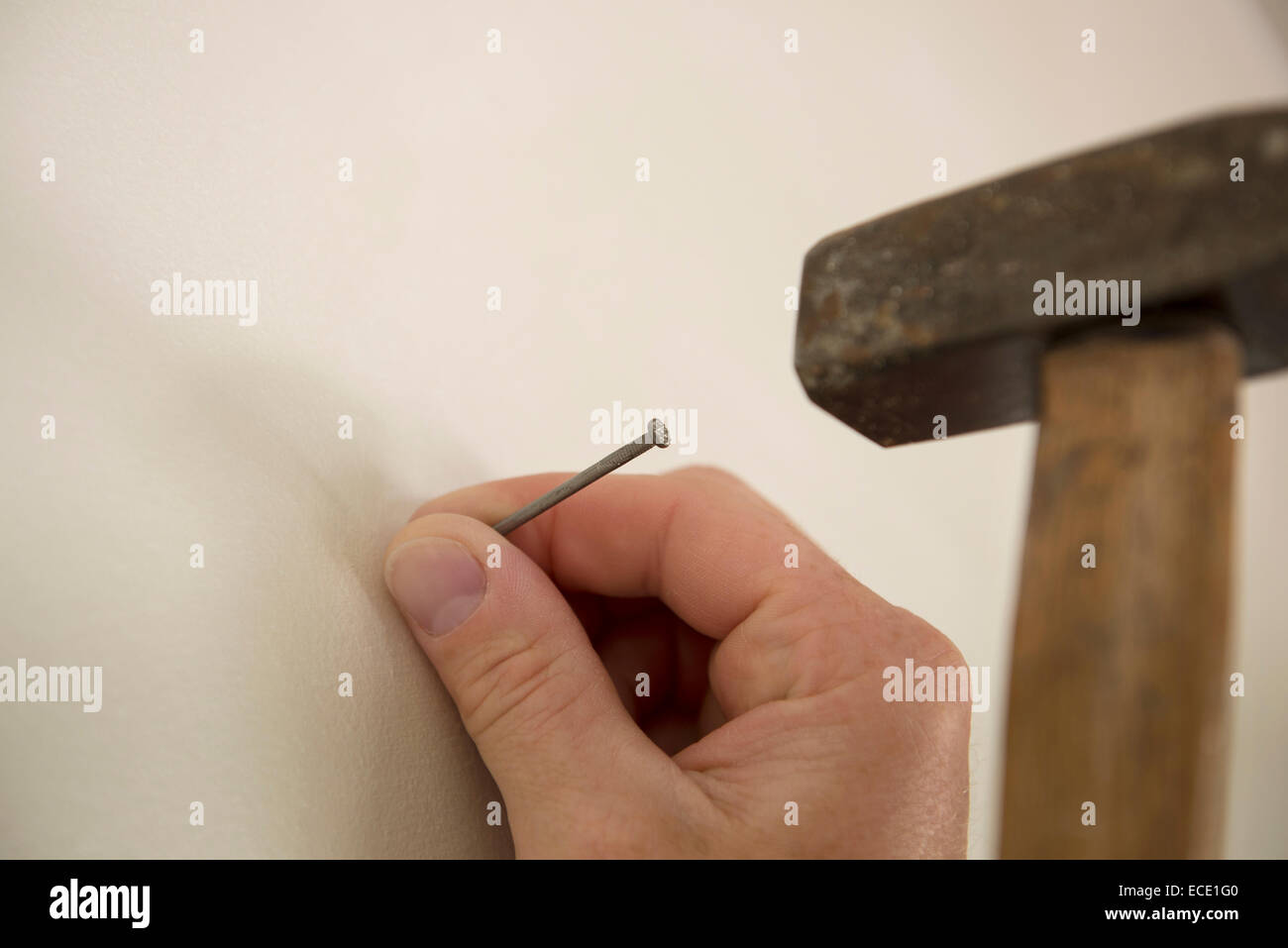 Hand detail finger hammer nail wall Stock Photo Alamy
