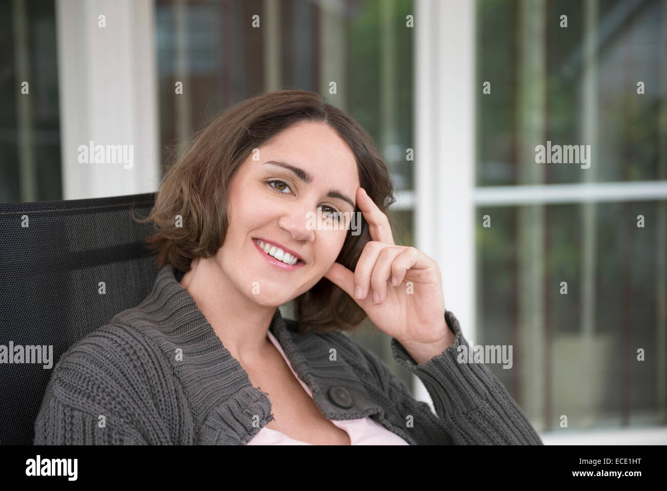 Portrait woman smiling sitting terrace happy Stock Photo - Alamy