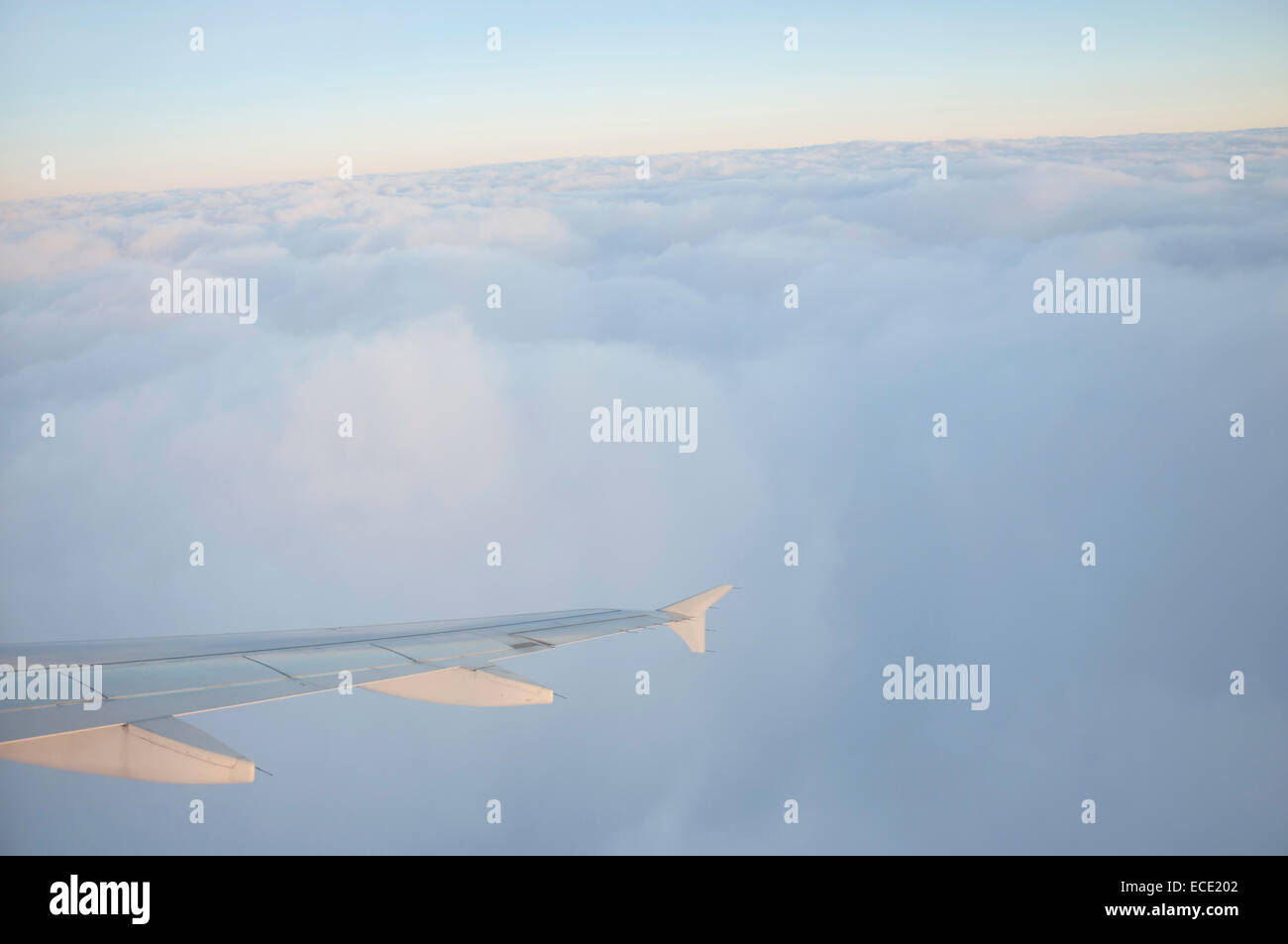 Aerial view of airplane flying over clouds at sunset Stock Photo - Alamy