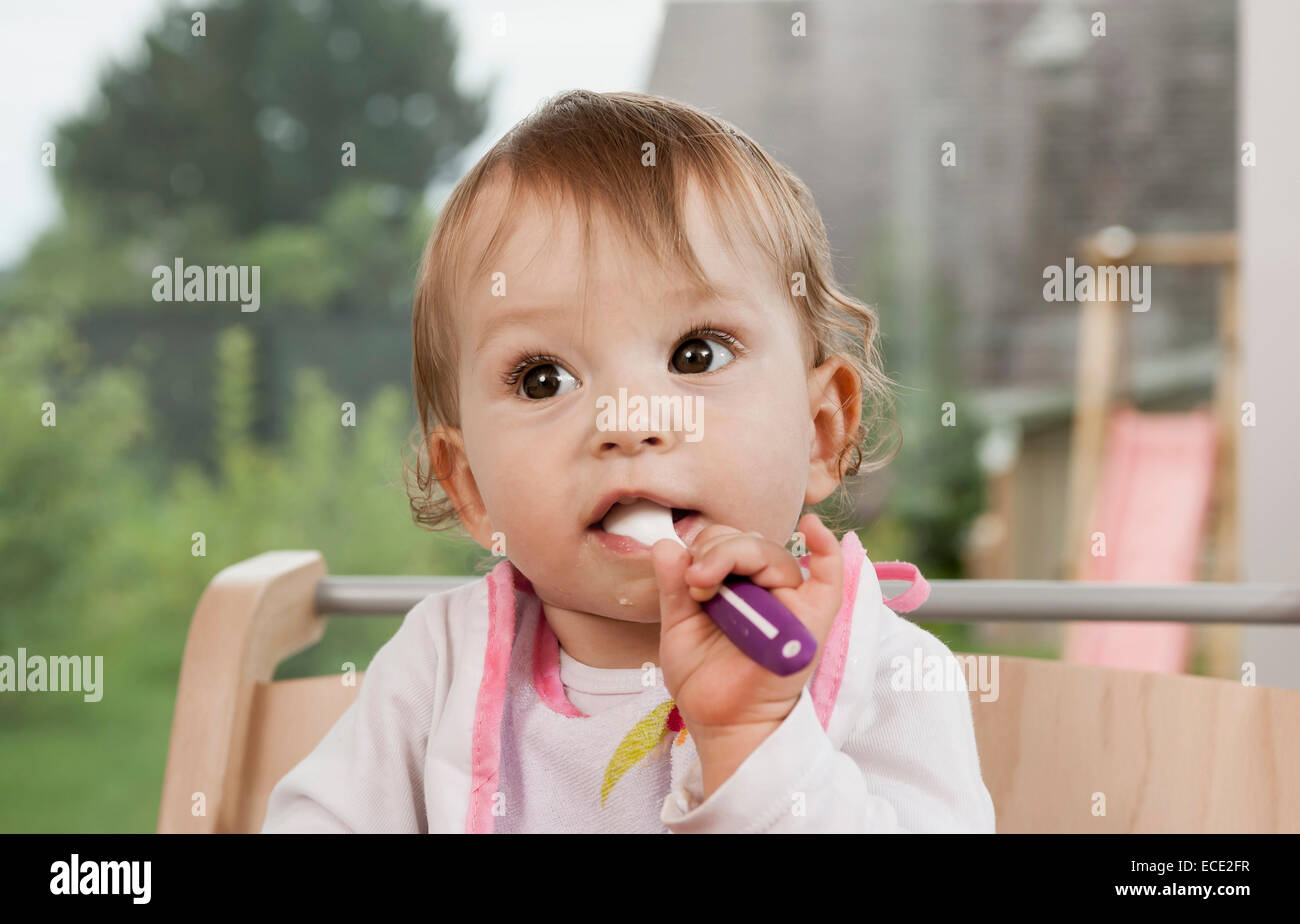 Baby girl 1 year old portrait spoon mouth Stock Photo