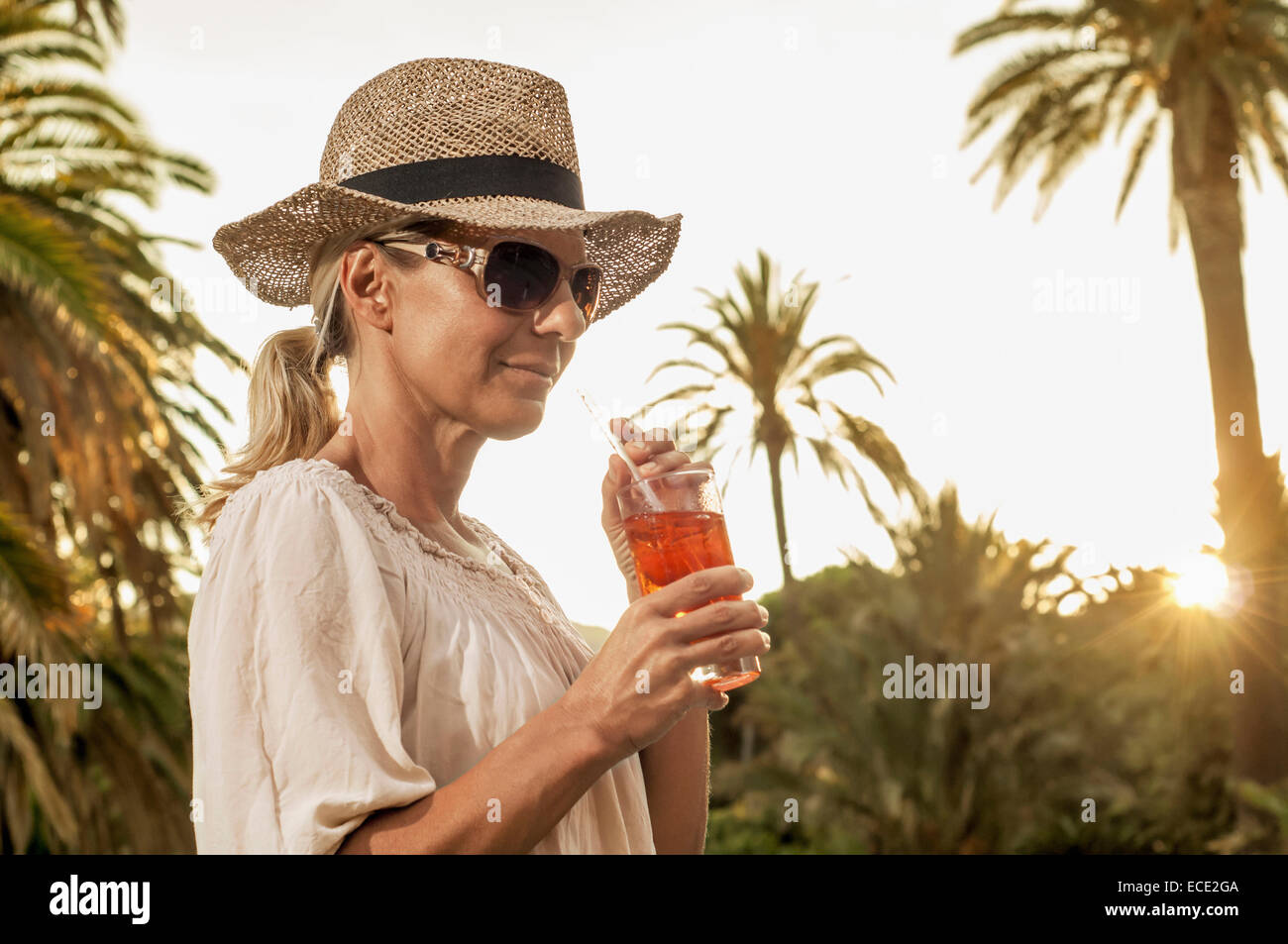 Chic mature blond woman holiday glamorous cocktail Stock Photo