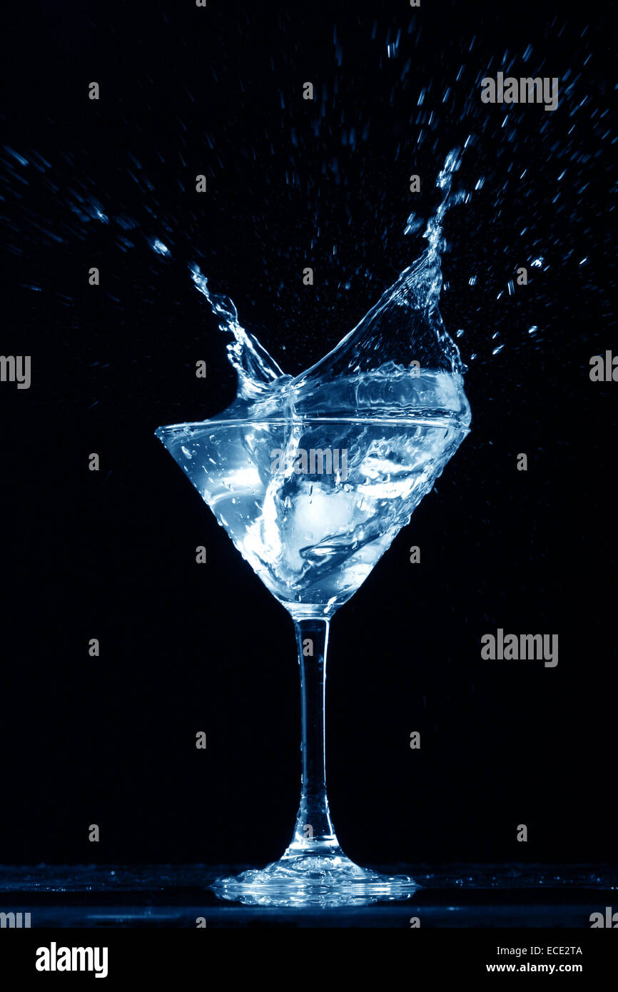 alcohol splash on black background Stock Photo - Alamy
