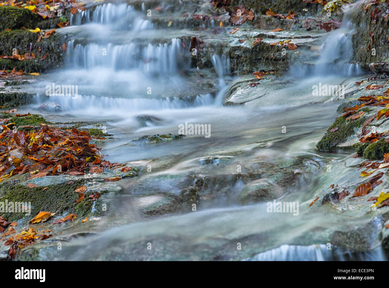 Waterfall in the forest in autumn, Monte Cucco Regional Park, Umbria, Italy Stock Photo