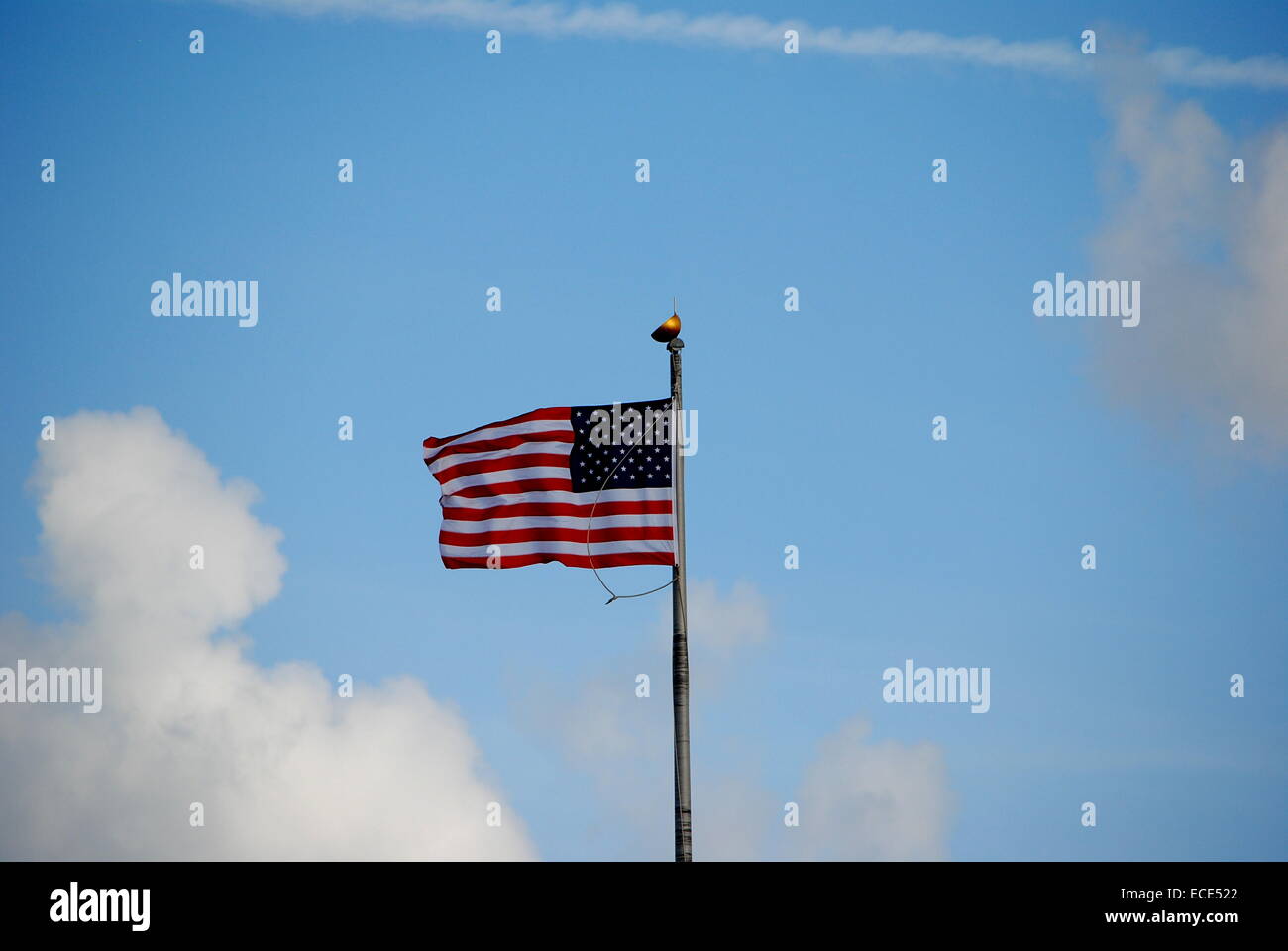The American Flag,flying gracefully,against a partly cloudy sky. Stock Photo