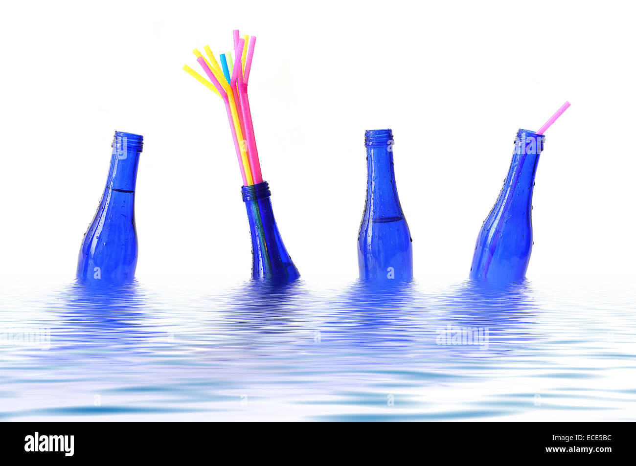Blue bottles with coloured straws floating in water Stock Photo Alamy