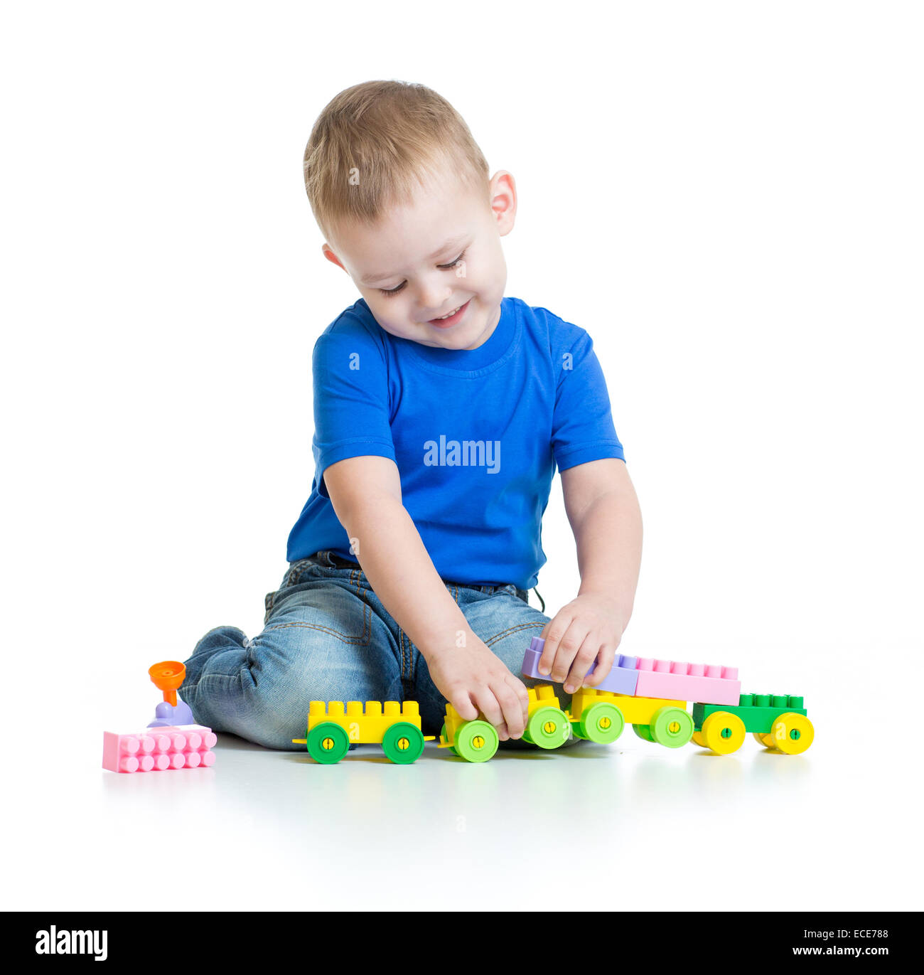Kid boy playing with train toy sitting Stock Photo