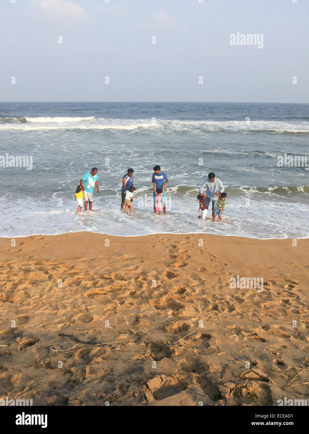 India, Fathers and children (2-7) playing on beach Stock Photo