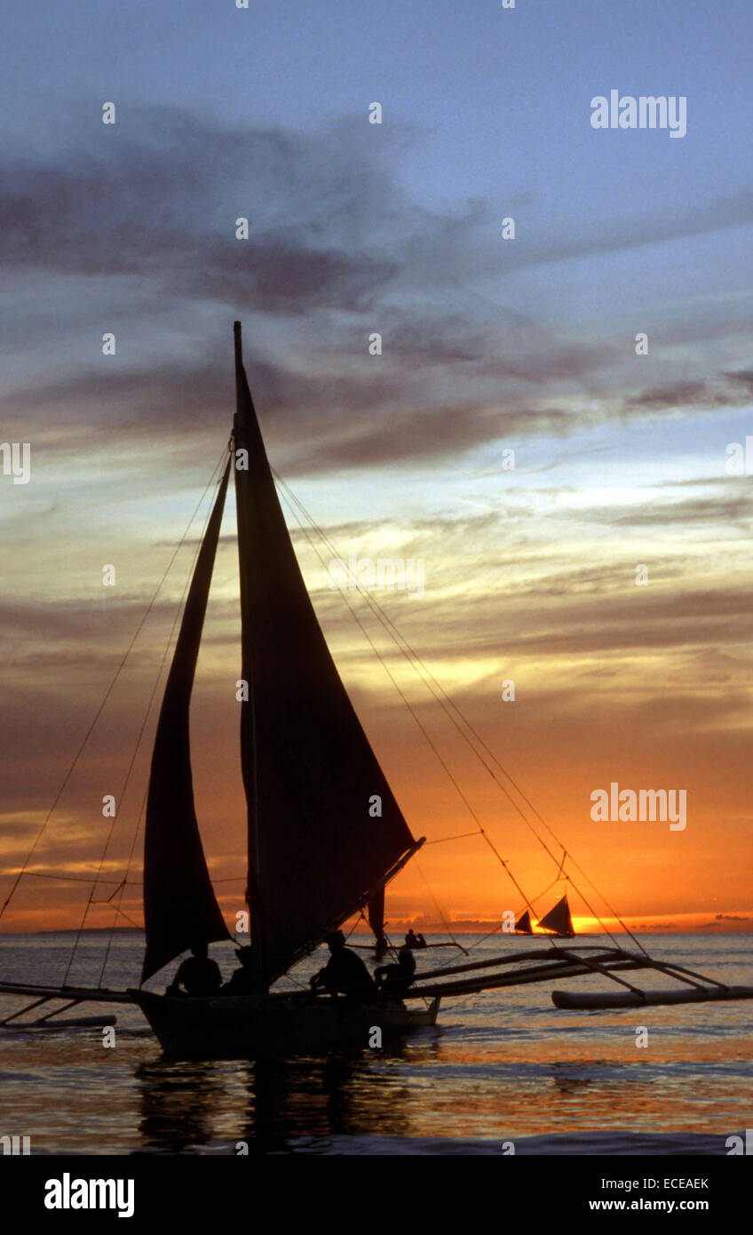 Sunset in White beach. Boracay. Boats or bankas saling near the coast. Romantic. Boracay is a small island in the Philippines lo Stock Photo
