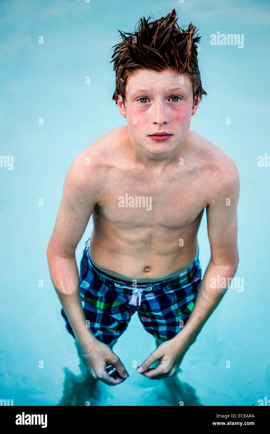 Portrait Of A Redhead Boy Standing In Swimming Pool