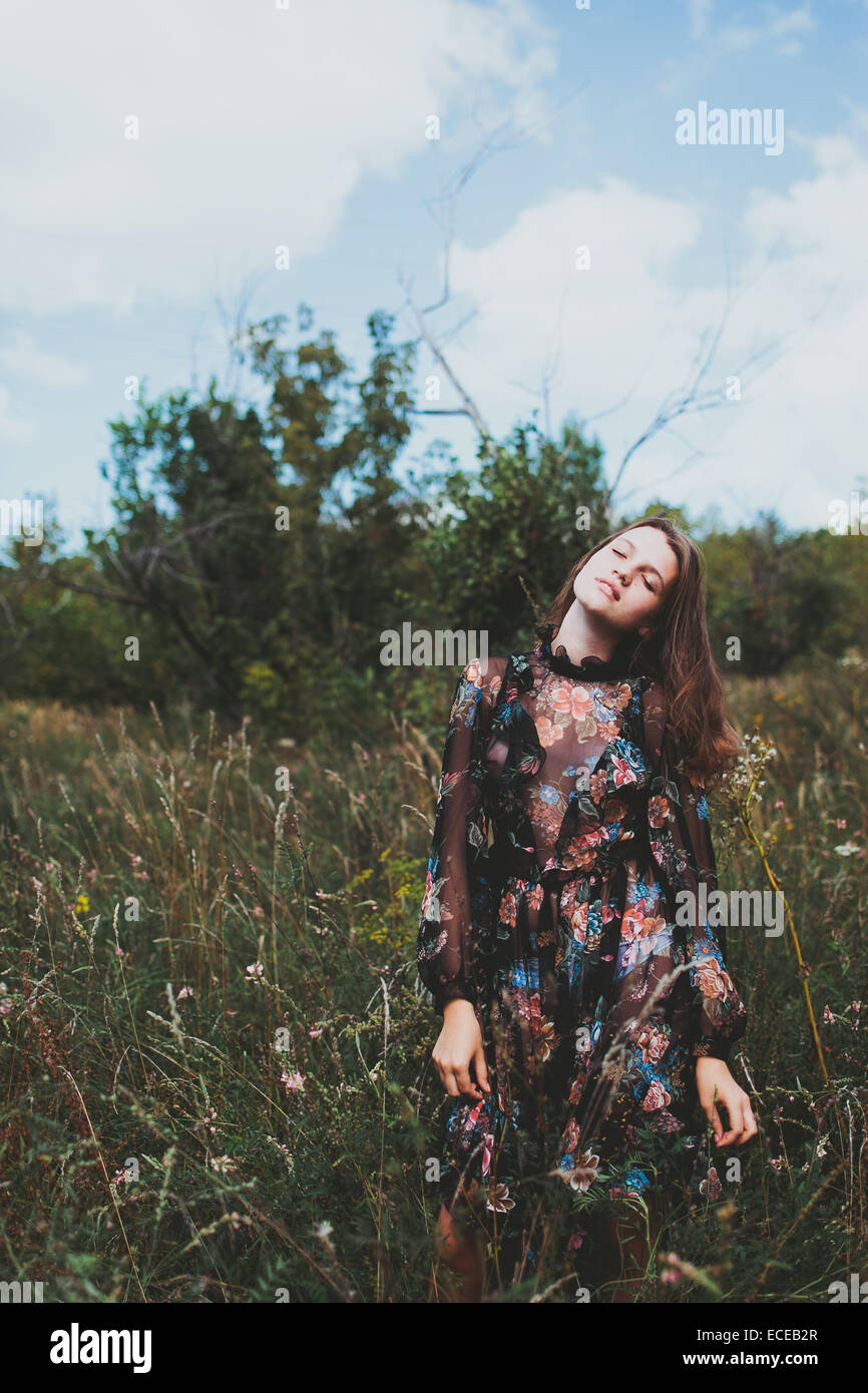 Portrait of a teenage girl standing in a meadow Stock Photo - Alamy