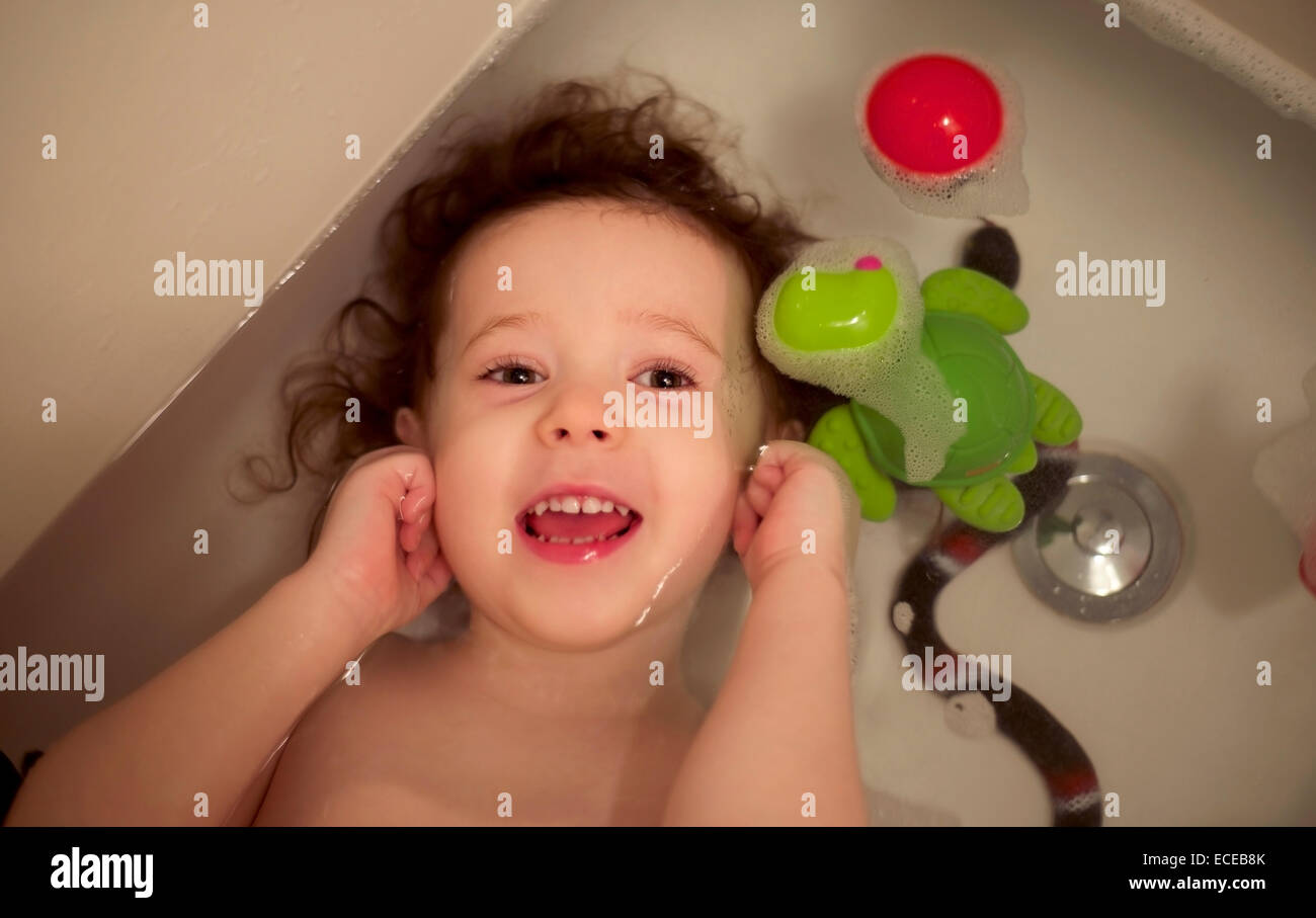 Toddler girl (23) with curly hair in bath Stock Photo Alamy