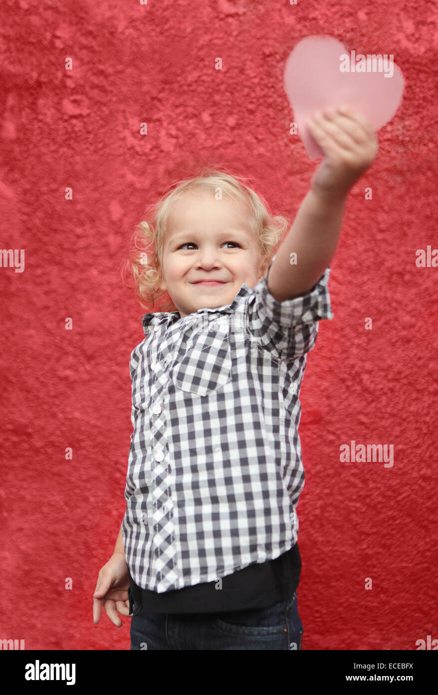 Boy holding paper heart Stock Photo