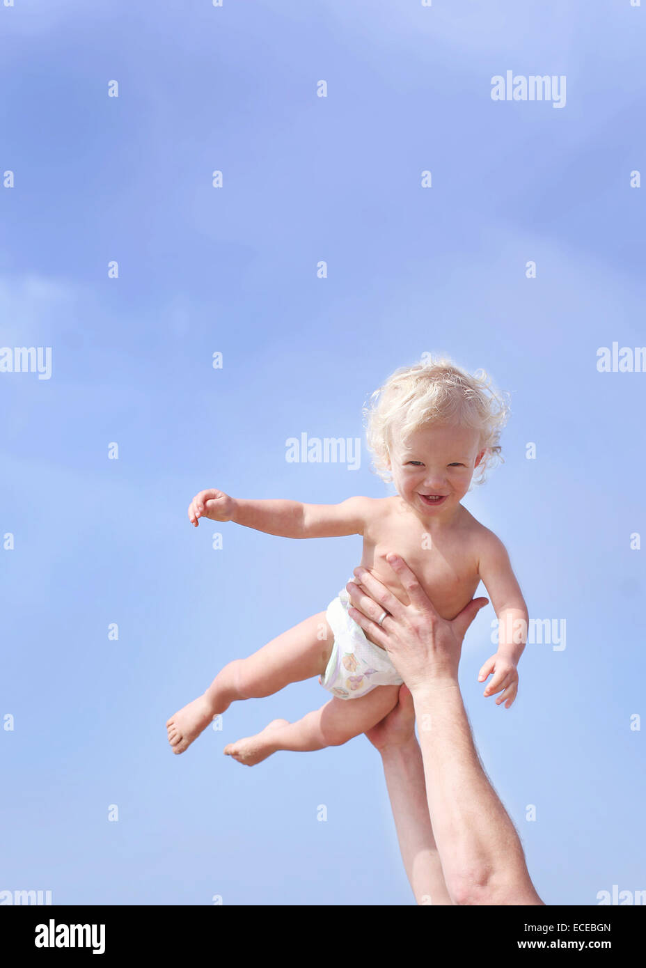 Toddler being lifted in air Stock Photo