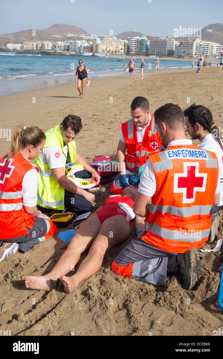Red Cross lifeguards and rescue services rescue simulation on beach in