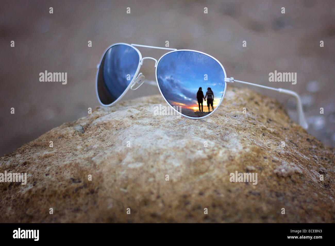 Reflection of couple in sunglasses Stock Photo