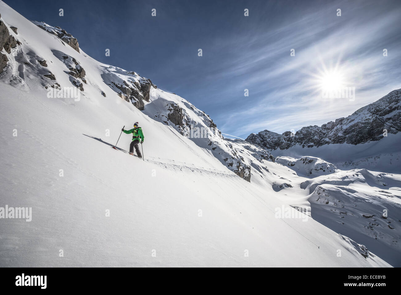 Austria, Male skier heading uphill Stock Photo