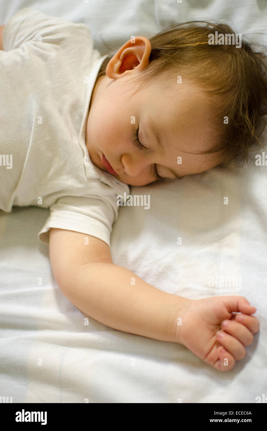 Baby boy sleeping on a bed Stock Photo