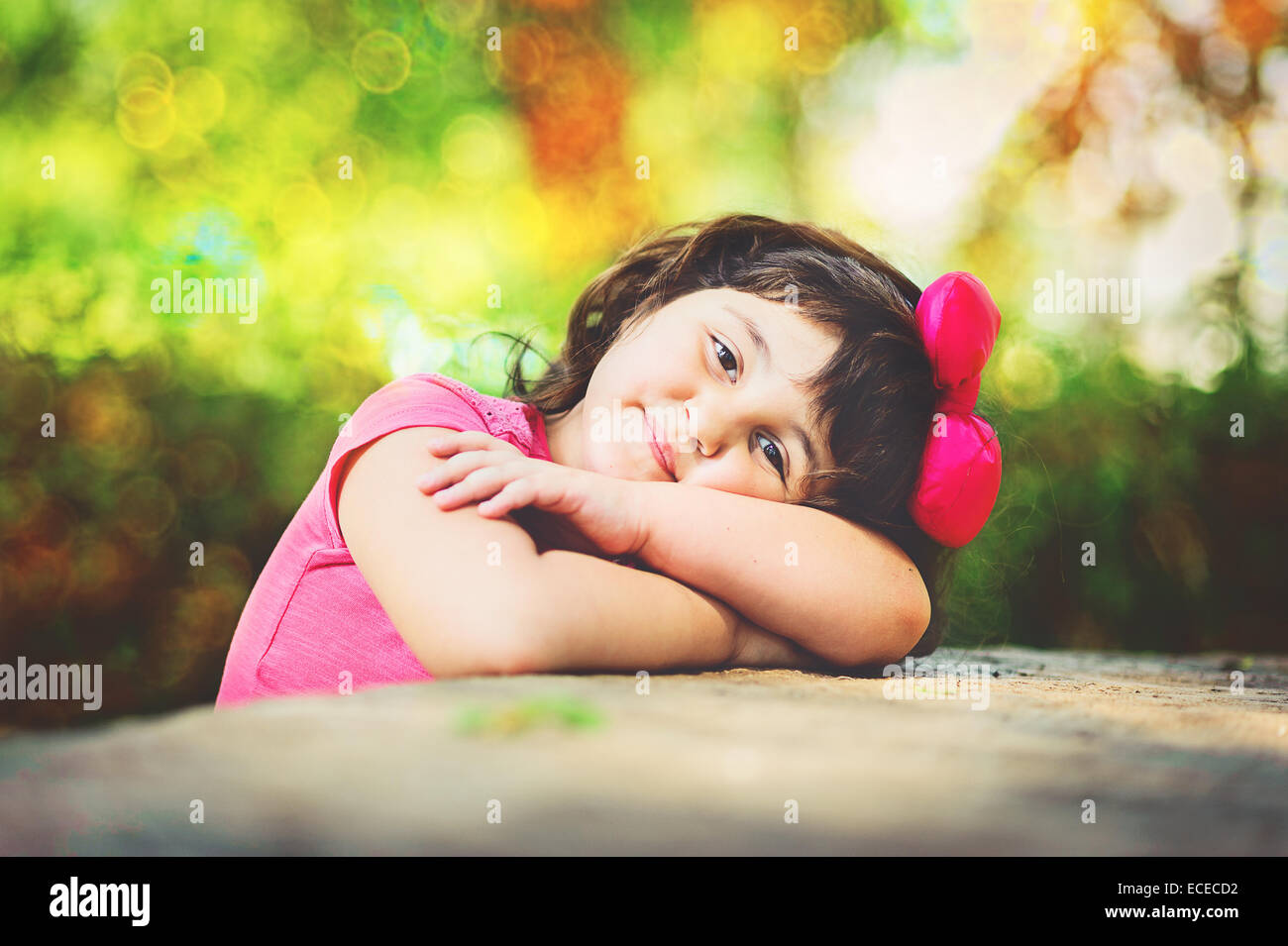 Portrait of girl wearing pink t-shirt and hair bow Stock Photo