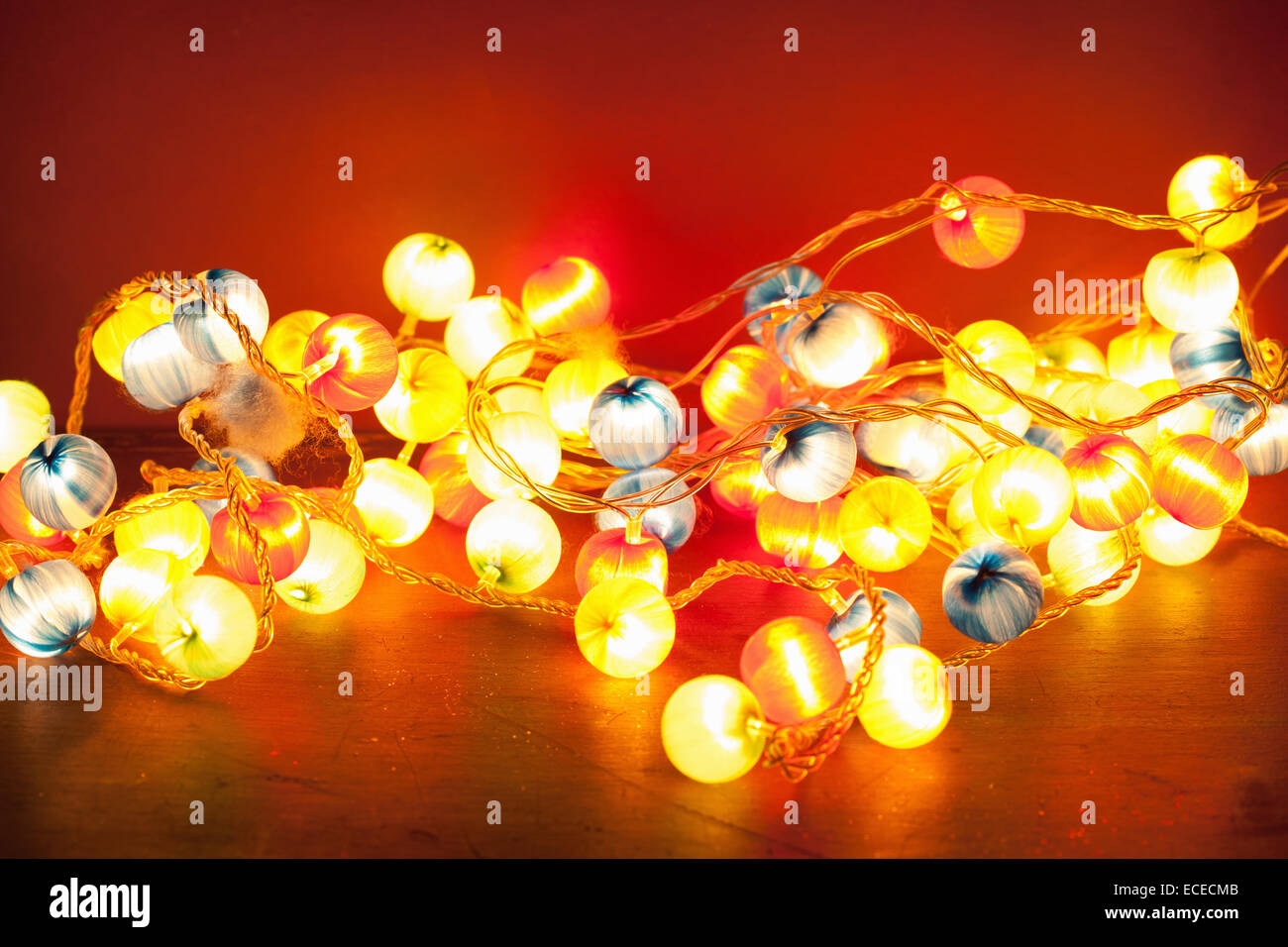 burning christmas lights over red background Stock Photo Alamy