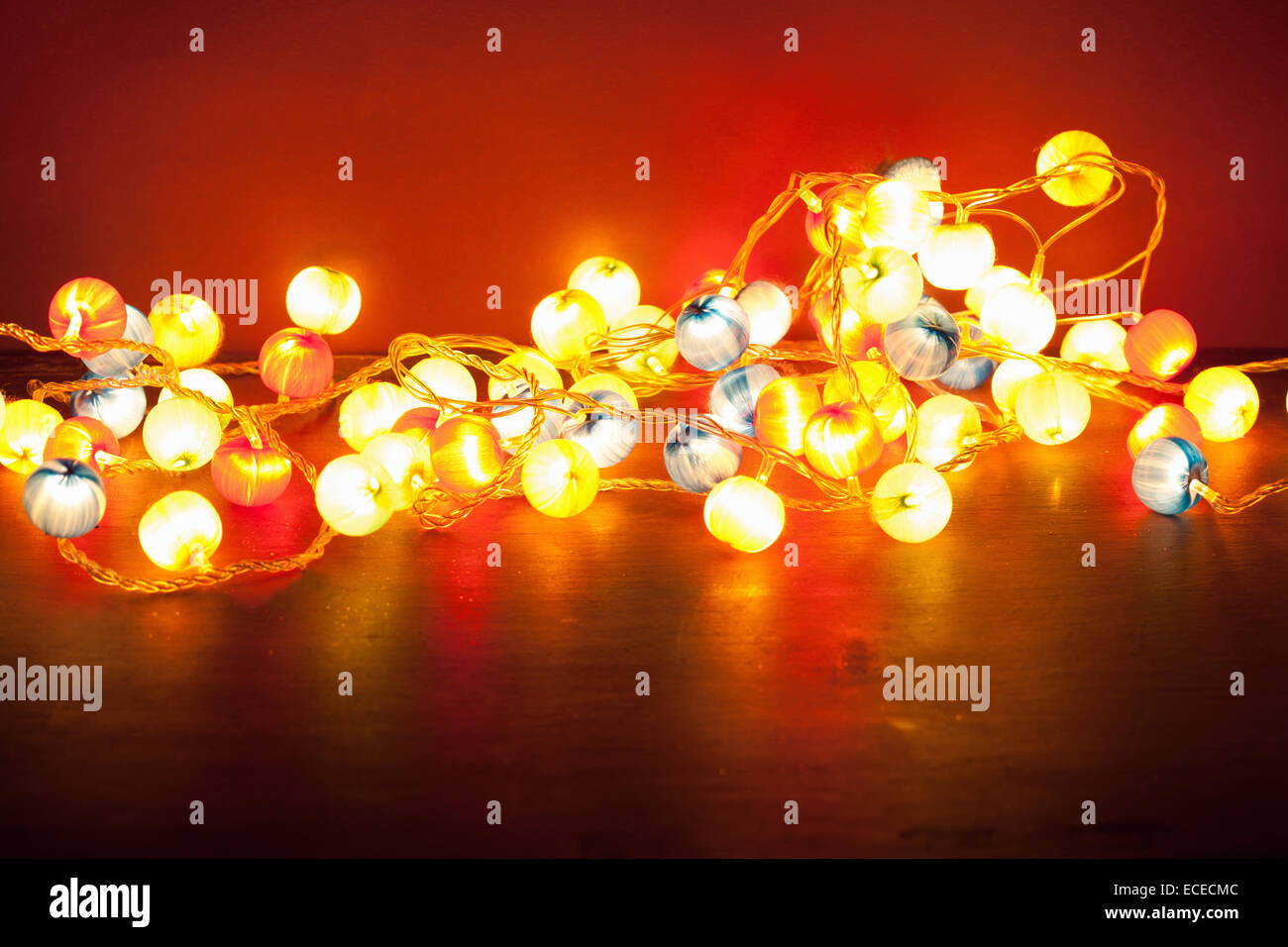 burning christmas lights over red background Stock Photo Alamy