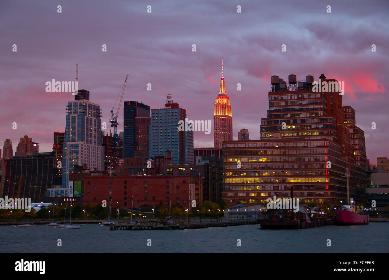 NEW YORK - OCTOBER 19 : Pier 45 and Empire state building facade shines at sunset. It was world's tallest building for more than Stock Photo
