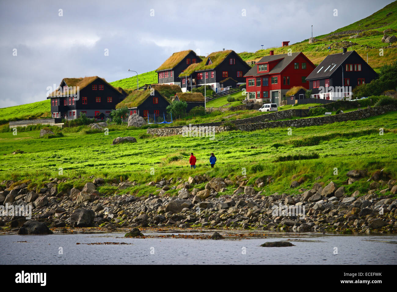 Couple walking in Kirkjubøur, Faroe Islands Stock Photo