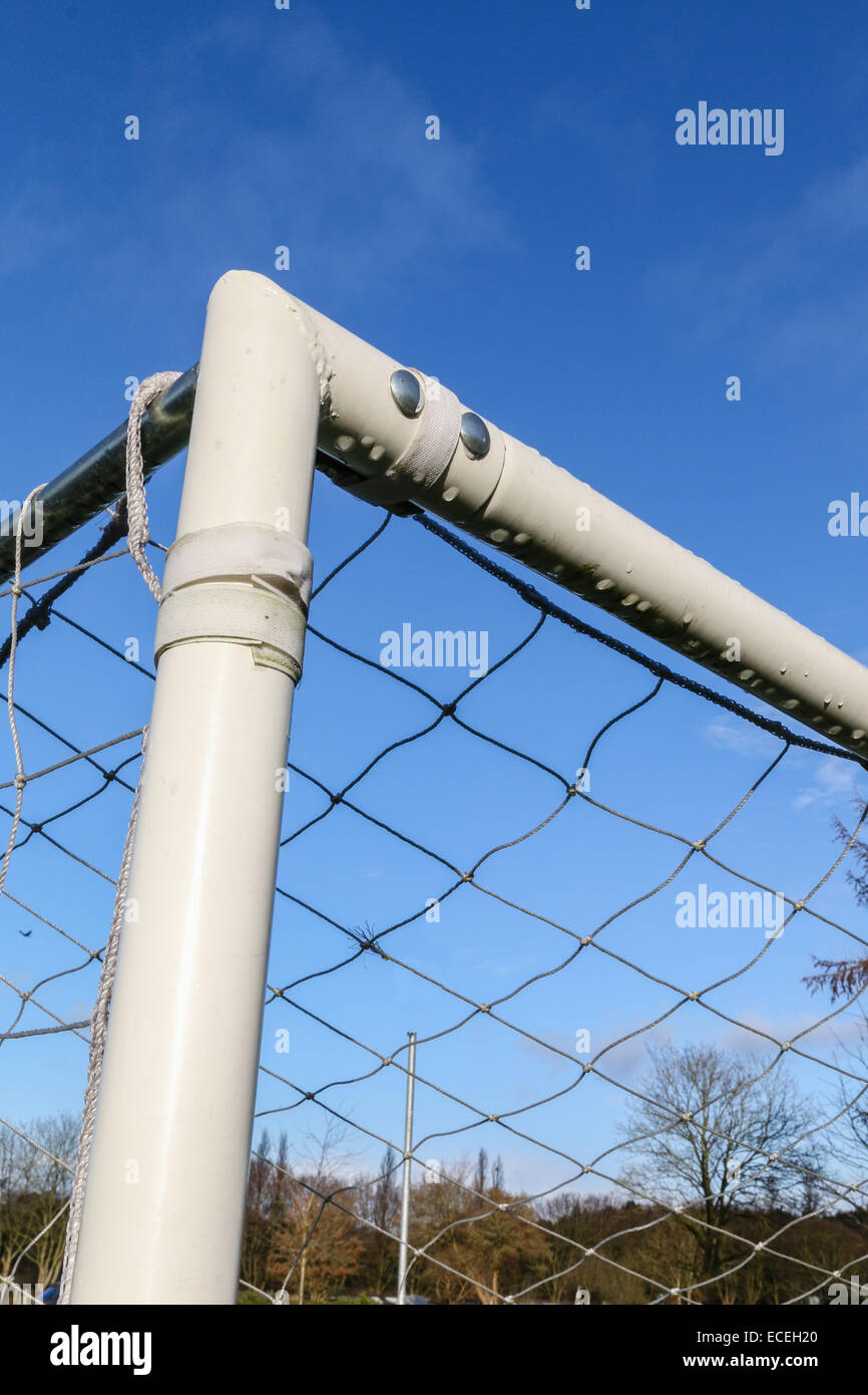 Corner of a soccer goalpost with net against a blue sky. Stock Photo