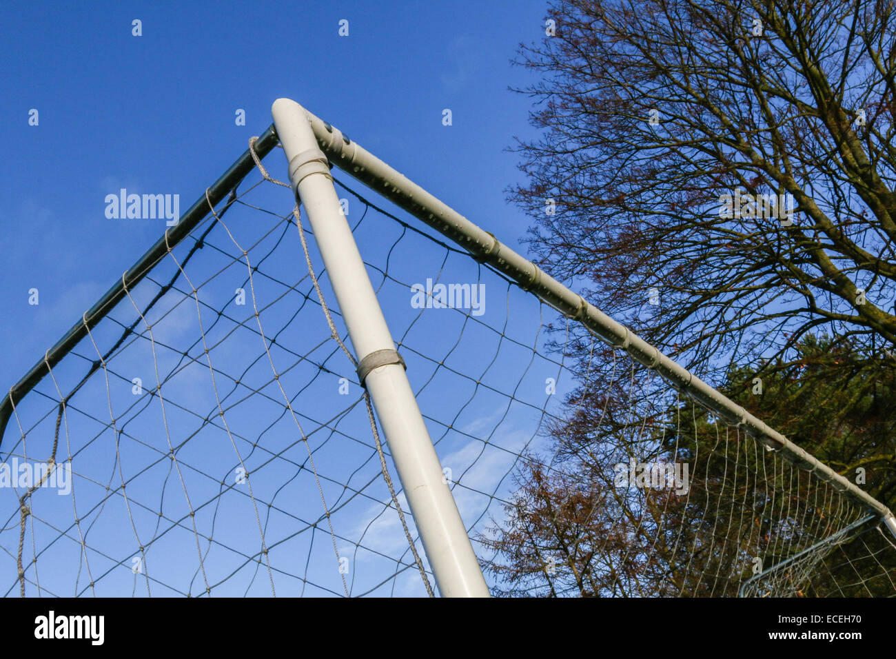 Corner of a soccer goalpost with net against a blue sky. Stock Photo