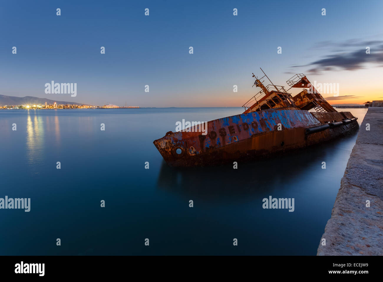 Sunken fishing ship below water, abandoned in the dock near Piraeus in Greece Stock Photo