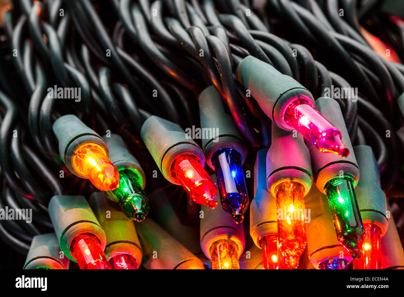 String of multicolor Christmas lights with green wiring Stock Photo - Alamy