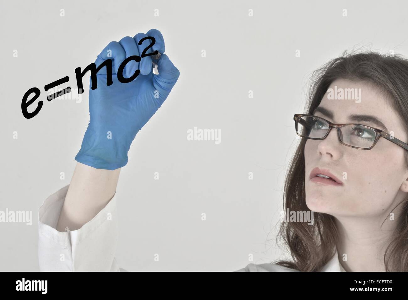 Had wearing protective latex gloves writing on a clear board using a marker Stock Photo