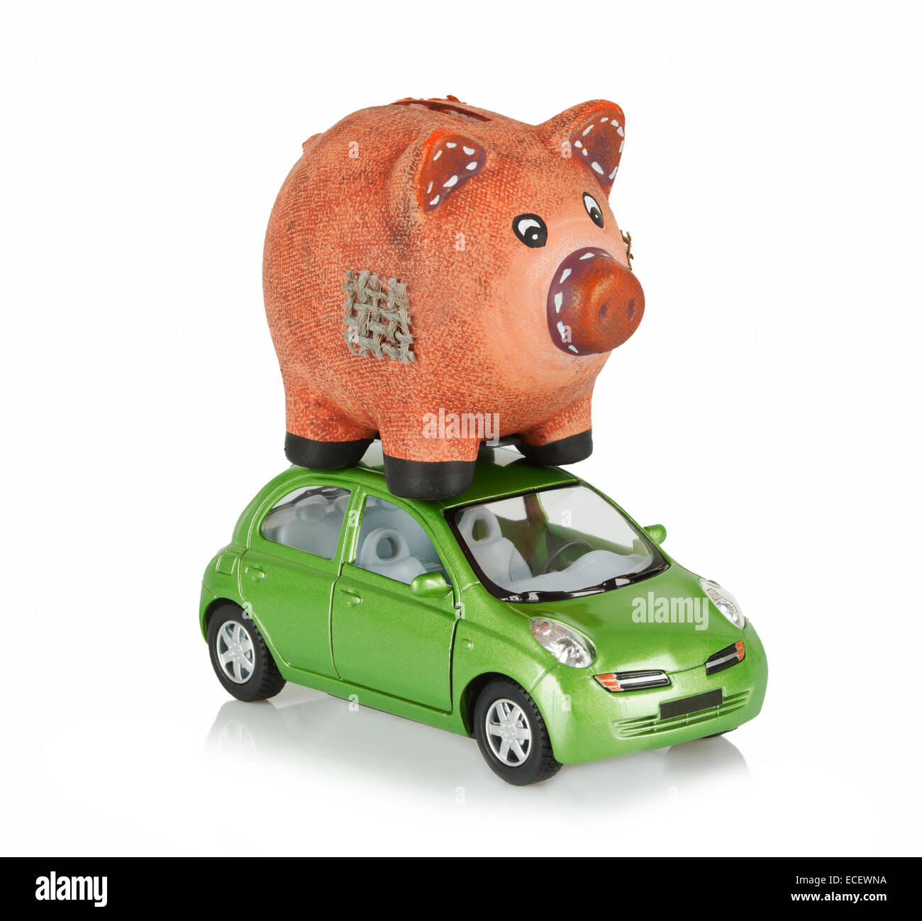 Small green car with an piggy bank on the roof. Stock Photo
