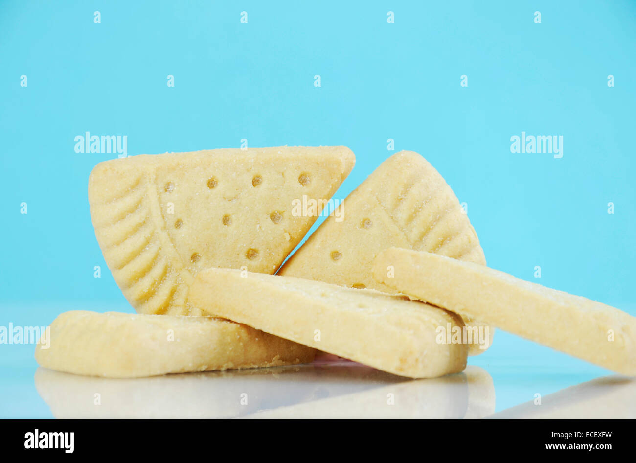Traditional Christmas shortbread triangle shape cookies against a pale blue and white background. Stock Photo