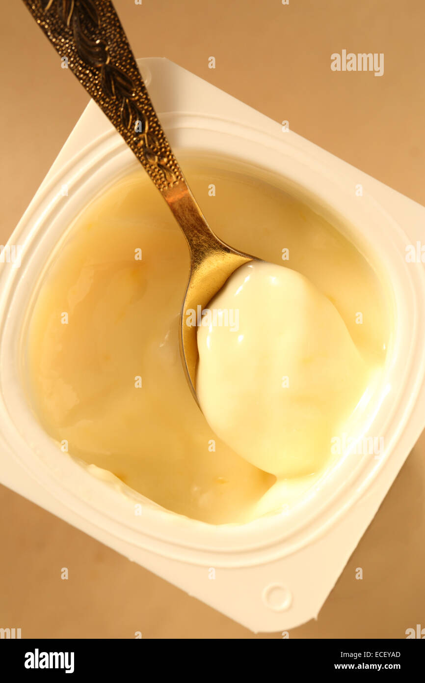 Yogurt pot with full spoon Stock Photo Alamy