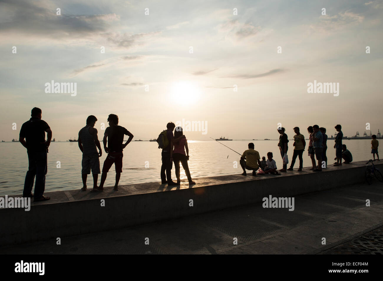 People standing along Manila Bay Stock Photo