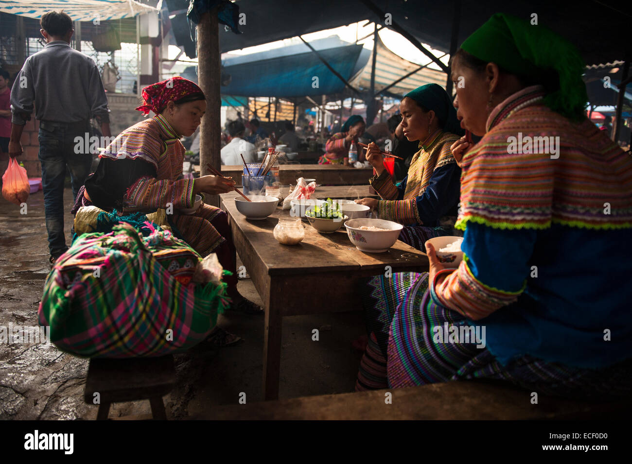 Hmong women eating at the Bac Ha Sunday Market Stock Photo