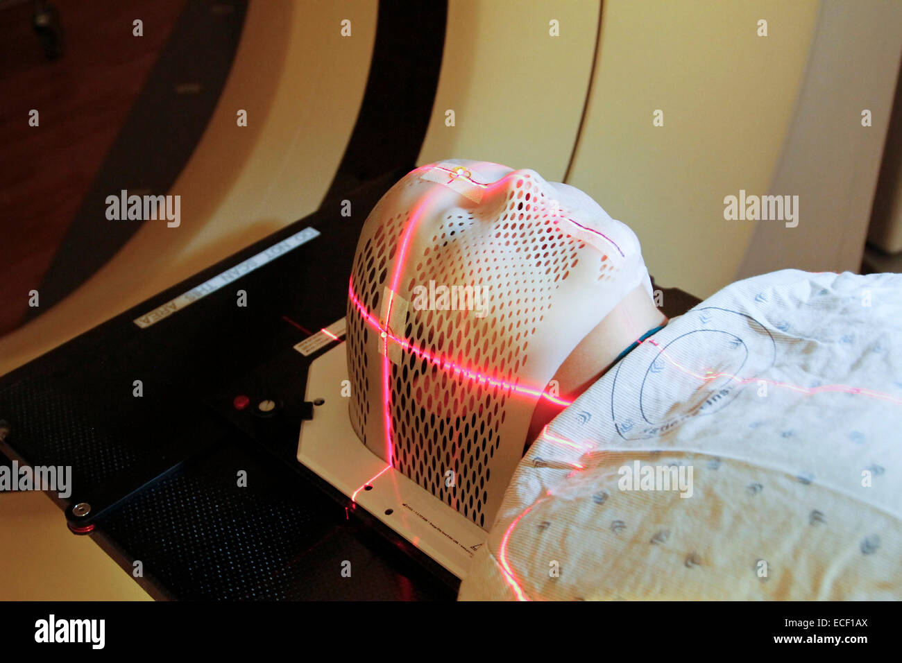 Lasers are used to position a patient model wearing a short face mask in a computed tomography (CT) scanner to obtain images of Stock Photo