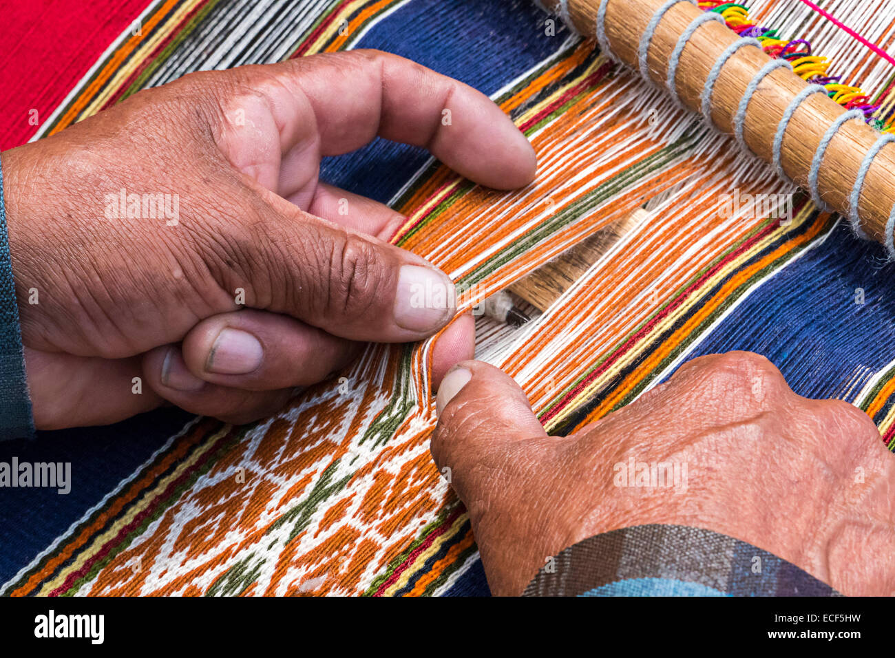Peruan weaver weaves traditional  carpet Stock Photo