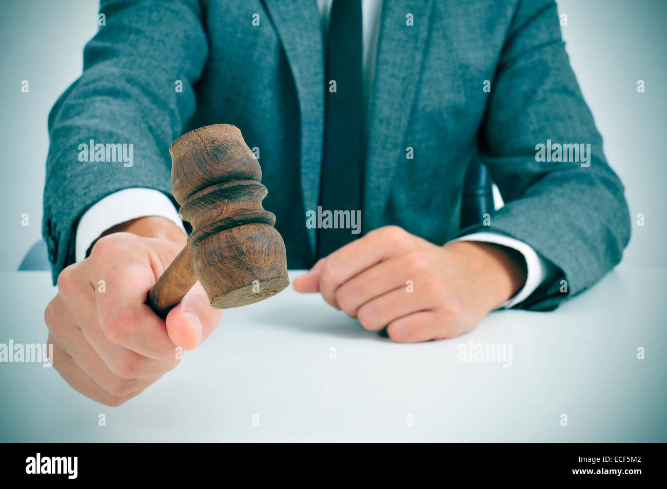closeup of a man in suit about to struck a gavel Stock Photo