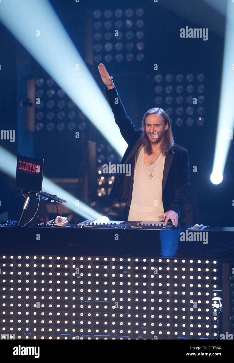 Berlin, Germany. 12th Dec, 2014. The French House DJ and music producer David Guetta stands on stage during the final of the TV show 'The Voice of Germany' in Berlin, Germany, 12 December 2014. The show is aired on the Sat.1 TV channel. Photo: Joerg Carstensen/dpa/Alamy Live News Stock Photo