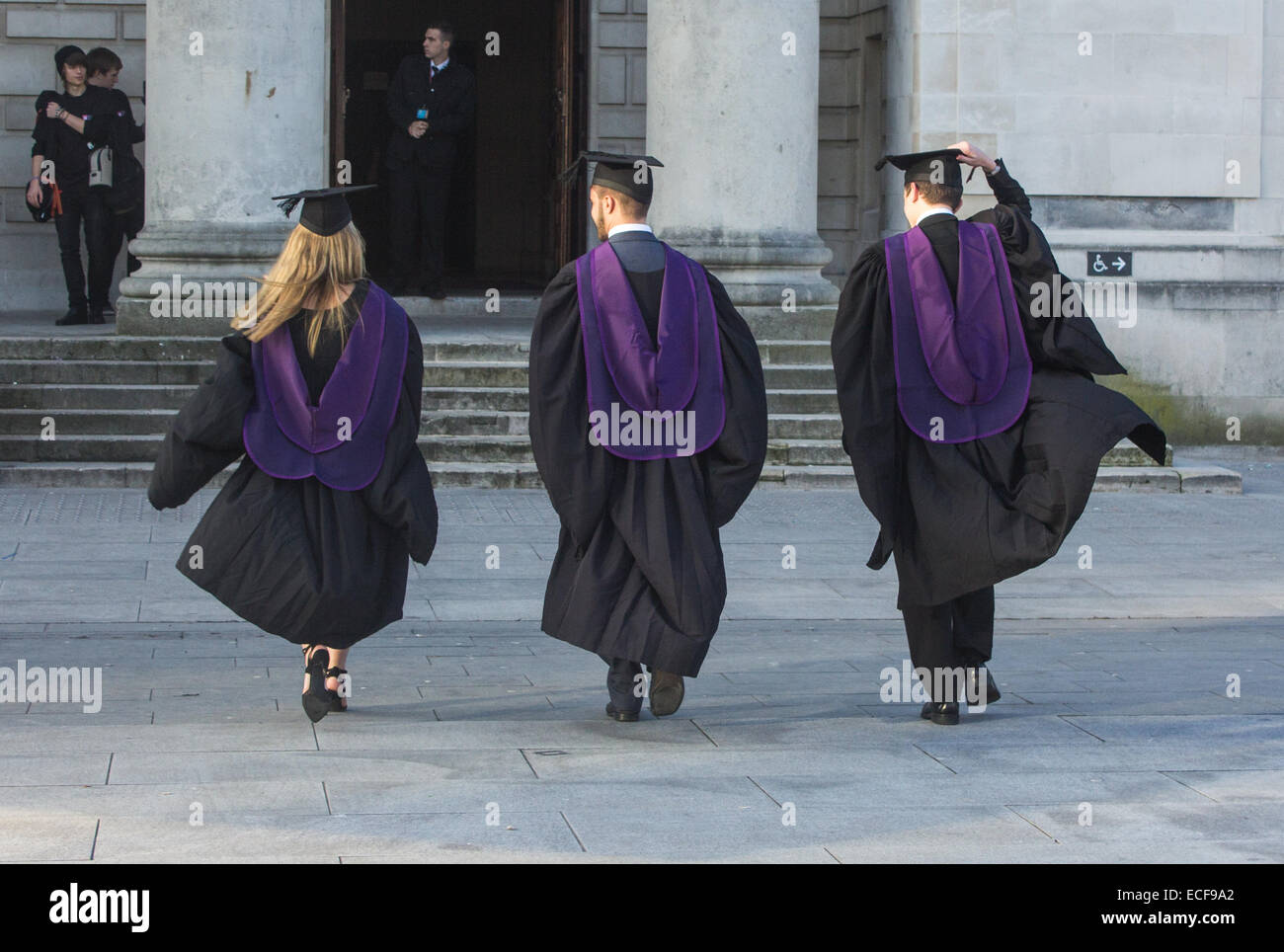 Three graduates walking towards Southampton Guildhall for the Solent university graduation ceremony n 2014. Stock Photo