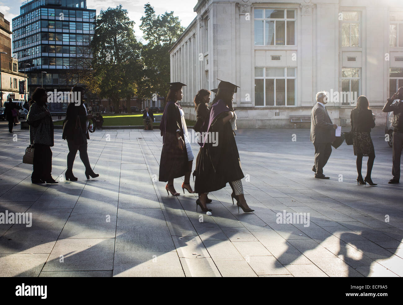 Girls and family walking towards Southampton Guildhall during Southampton Solent graduation week. Stock Photo