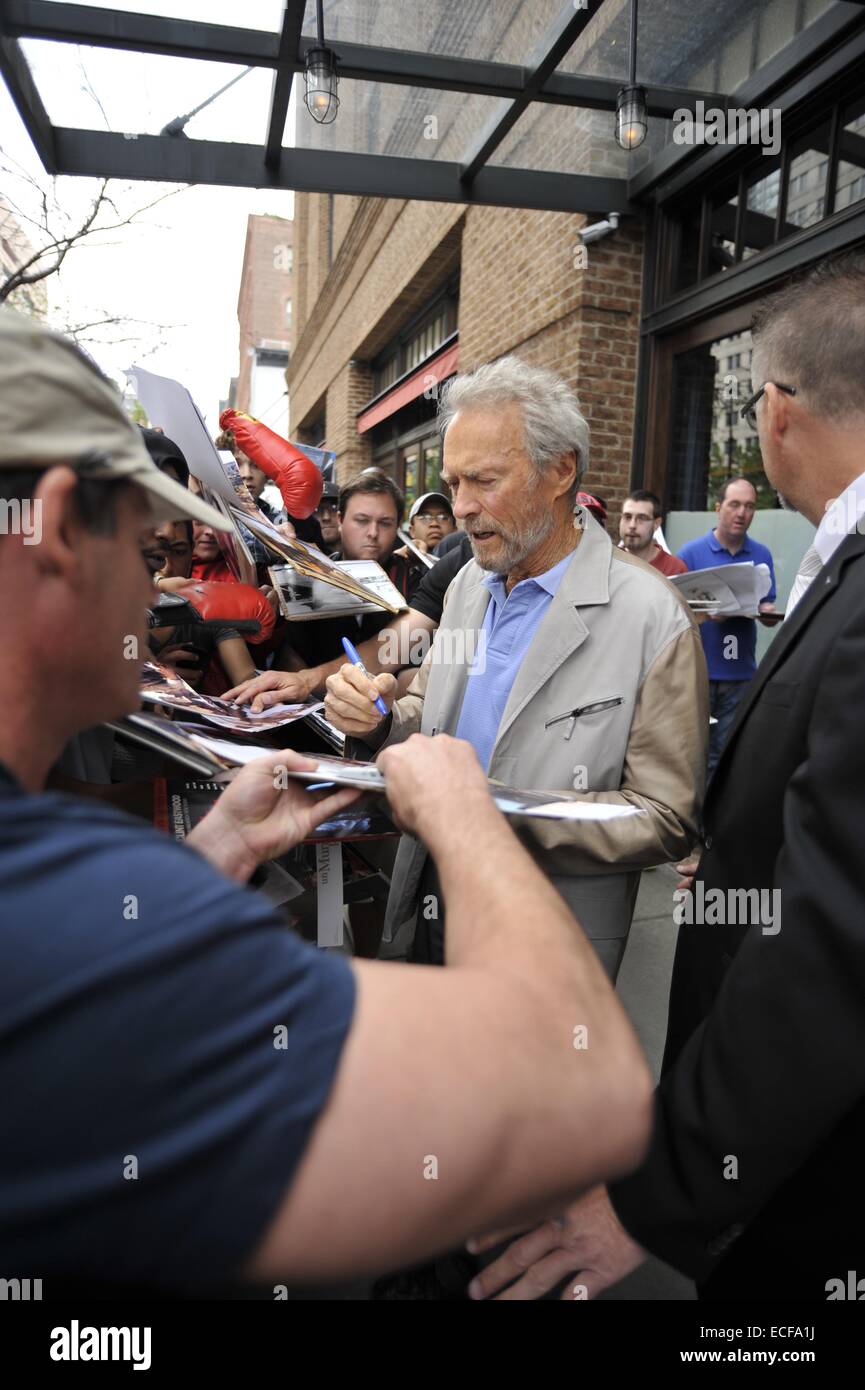 Clint Eastwood signs autographs as he leaves his hotel in Manhattan