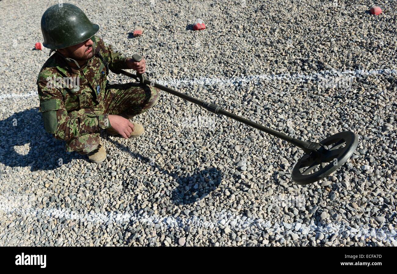 An Afghan soldier uses a mine detector during a demining drill at camp Shaheen, a training facility for the Afghan National Army (ANA), located west of Mazar-e Sharif on December 13, 2014. German Defence Minister Ursula von der Leyen is on a two-day visit in Afghanistan. PHOTO: JOHN MACDOUGALL/dpa Stock Photo