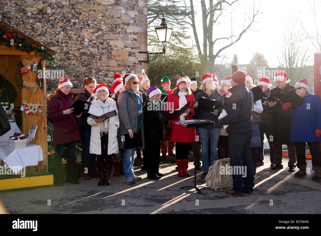 Carol singers performing in The Close Winchester Cathedral Hampshire UK  Singing Christmas carols Stock Photo