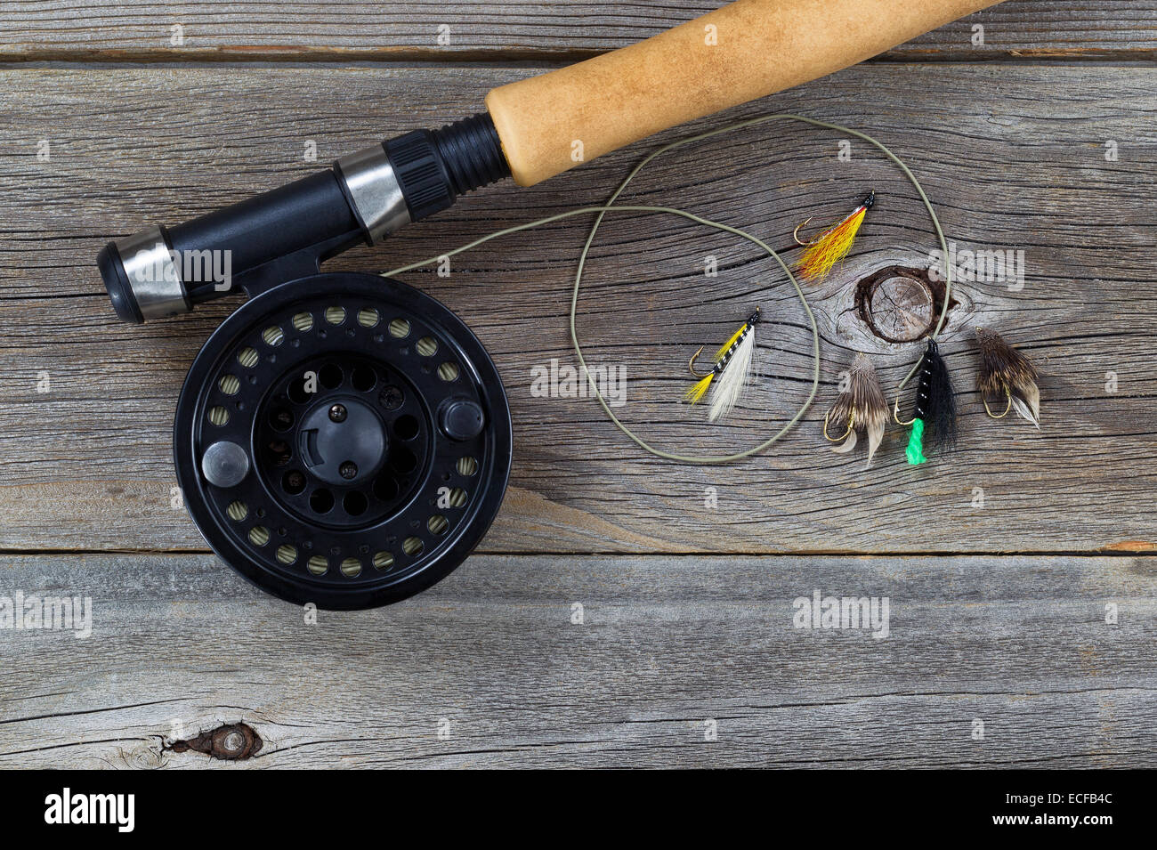 Three salmon flies that were probably homemade on the cork handle of an old fly  fishing rod resting on a whicker tackle box. From a collection of vint  Stock Photo - Alamy