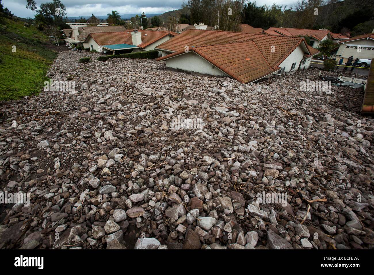 (141213) -- LOS ANGELES, Dec. 13, 2014 (Xinhua) -- Houses buried by rocks and debris are seen in Camarillo Springs, about 80km northwest to Los Angeles, California, the United States, Dec. 12, 2014. A soaking storm swept into Southern California, causing several mudslides, flooding streets and cutting power to tens of thousands Friday after lashing the rest of the state with much-needed rain. (Xinhua/Zhao Hanrong) (zjy) Stock Photo