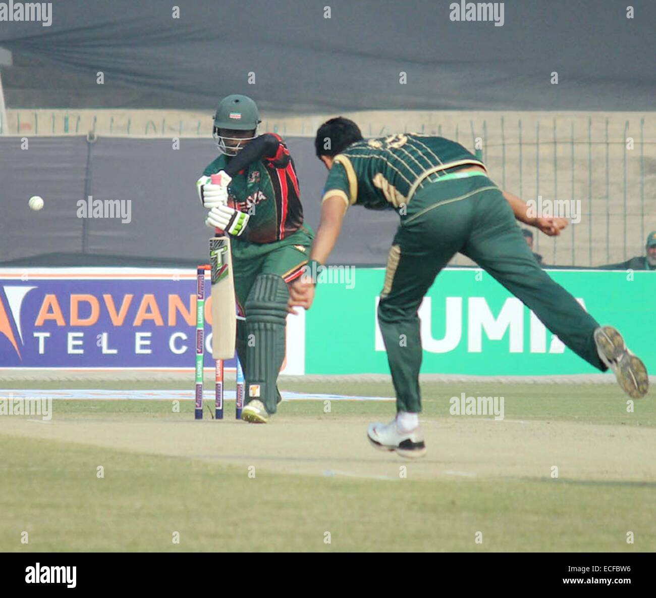 (141213) -- LAHORE, Dec. 13, 2014 (Xinhua) -- Kenyan player Nelson Odhiambo (L) plays a shot during the first One Day International (ODI) match between Pakistan-A and Kenya at the Gaddafi Cricket stadium in eastern Pakistan's Lahore, Dec. 13, 2014. Pakistan won by 9 wickets. (Xinhua/Sajjad) Stock Photo