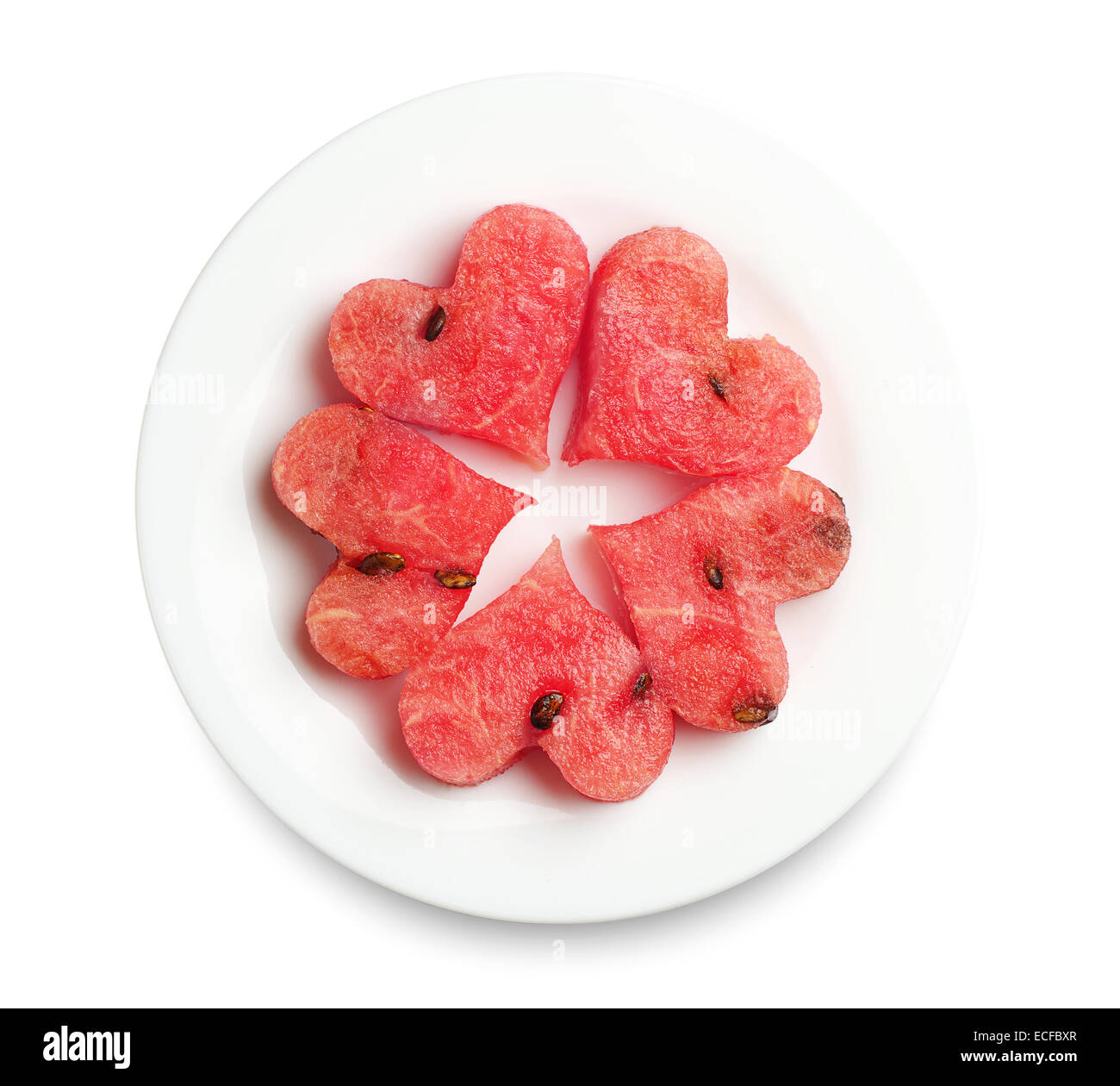 Slices of watermelon in the heart shape on white plate Stock Photo