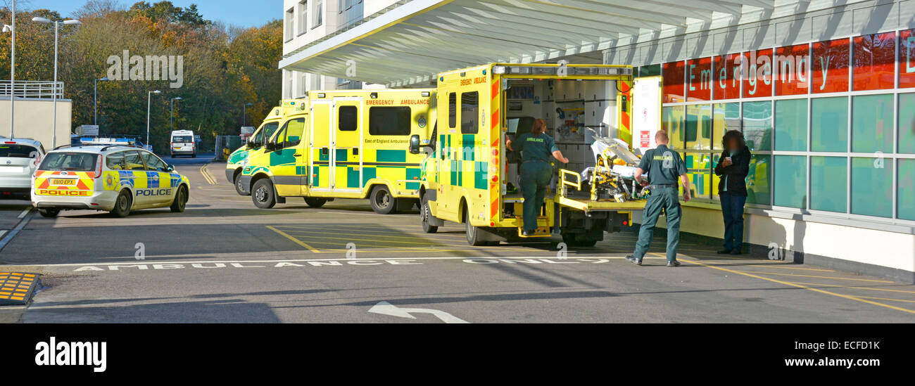 East of England Ambulance paramedics reload equipment after delivering patient to hospital emergency department Stock Photo